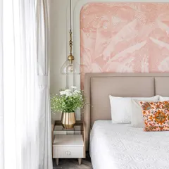 A closer look at the bedside styling in 'Project Lily.' We designed a custom side table with a fluted drawer front and a brass vase, complemented by a vintage-style glass pendant light.