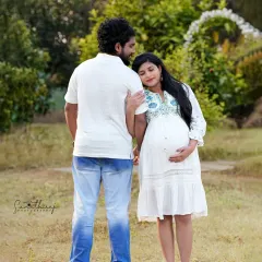 A candid and relaxed outdoor couple portrait. The natural setting and their easy interaction create an authentic and heartwarming image of their journey together.