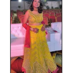 Another vibrant yellow lehenga option for a Mehendi function. The mirror work on the blouse and the pink border add a festive touch.