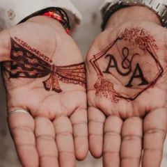 I love this combination of modern and traditional for a groom's mehendi. On one palm, we have a clean, geometric frame with the couple's initials, and on the other, a classic groom's turban design. It’s the perfect balance of personal and stylish.