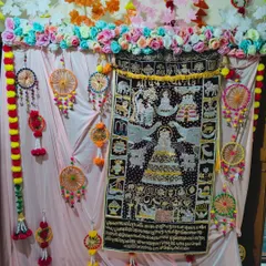 Here is a vibrant backdrop for a Kalpasutra puja. I centered the family's embroidered Kalpasutra tapestry and surrounded it with colorful handmade dream catchers, artificial flower garlands, and soft pink drapes to make it the focal point of the home.