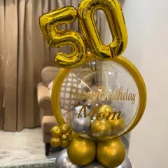 A different angle of the 50th birthday balloon arrangement, showing the layered gold and silver balloons at the base that give it a sturdy and stylish foundation.