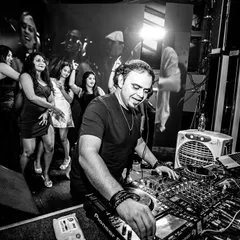 A classic black and white shot capturing the focus and action at the DJ booth. Even with the party raging, my attention is locked on delivering a seamless mix.