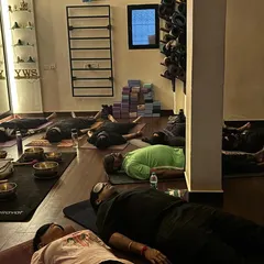 Students resting in Yog Nidra, a state of conscious deep sleep, during a sound bath. The eye pillows help to quiet the mind, allowing for a deeper meditative experience.
