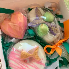 A whimsical mermaid gift box featuring three unique soaps: a donut soap with a mermaid tail, a heart-shaped soap, and a detailed mermaid tail and seashell soap. It's a dreamy combo for any little mermaid fan.