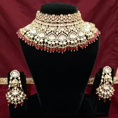 This Kundan choker set is detailed with rich red beads, making it a perfect match for a traditional red bridal lehenga.