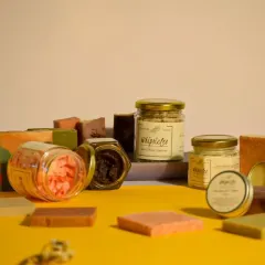 Every July, we highlight our commitment to reducing single-use plastics. This is a glimpse of our product range, all housed in reusable glass jars and tin containers or wrapped in paper.