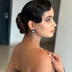 A side profile of the vintage finger waves, showing the beautiful S-shape pattern and the sleek low bun.