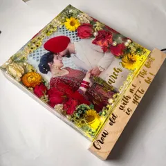 An angled view of the square block art, showing the thickness of the resin and the beautiful arrangement of the flowers. The LED light base makes it glow.