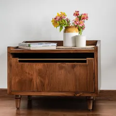 The Makam Bedside Table is a simple yet elegant piece with subtly turned ornate legs and a brass rod that serves as a handle. It is available in customizable sizes to perfectly fit your bedroom space.