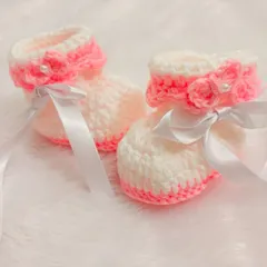 These pink and white booties are so sweet, with a pink fold-over cuff, a delicate rose, and a white satin ribbon.