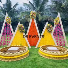 For this outdoor Haldi ceremony, I designed a vibrant setup using A-frame backdrops with marigold and tuberose flower hangings. The custom-made lotus-shaped urlis for the seating add a unique and traditional touch, making it perfect for photos.