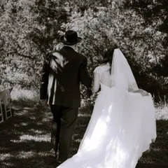 A timeless black and white shot of the bride and her father walking through the woods at their Austin wedding. It's a moment full of love and emotion.