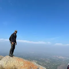Standing on one of the giant monolithic rocks that make Savandurga a unique trekking challenge.