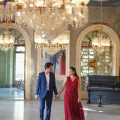 A candid walking shot through the same palace hall. The natural light and reflection in the mirror add a layer of classic romance to this pre-wedding photo.