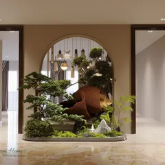 We designed this entryway around a grand faux statement tree to create a bold and serene focal point. Paired with an auspicious artifact, it sets a tone of peaceful luxury upon entering the home.