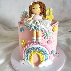 A different angle of this adorable doll and rainbow cake.