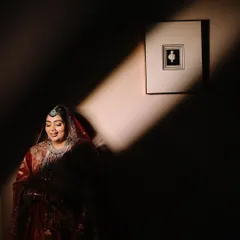 I love playing with light and shadow to create dramatic, artistic portraits. Here, a single beam of light illuminates the bride, creating a mysterious and captivating image that feels like a still from a movie.