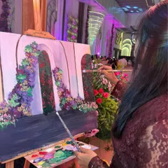 Here I am beginning a new piece at a wedding in Gurugram. I start by sketching the background and decor, ensuring the essence of the venue is captured before the couple makes their entrance.