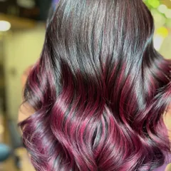 Who says you need bleach for bold color? This stunning plum red ombré was achieved without any bleach, protecting the hair's integrity while delivering a rich, vibrant, and head-turning result.
