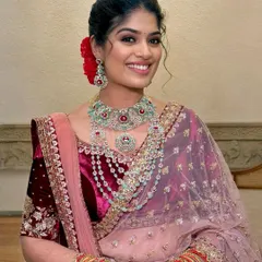 A perfect blend of grace and glam for a Sangeet or Reception. This look features defined kohl eyes, glowing skin, and a modern messy updo that speaks of timeless elegance.