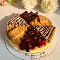 A top-down view of my assorted cheesecake, beautifully lit by the sun. This cake combines my most popular flavors: homemade blueberry, rich chocolate, and spiced Lotus Biscoff.