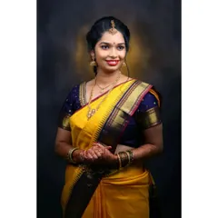 For this client's Varpooja ceremony, we chose a classic South Indian look. The makeup features defined eyes and a bright lip, complementing her beautiful yellow silk saree and traditional gold jewelry.