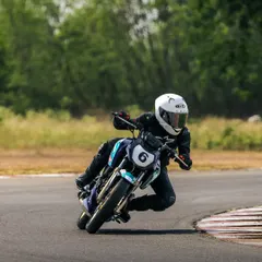 Demonstrating excellent body position, Poojita AK leans into a turn during a race. Her focus and technique are on full display, skills honed through our intensive racer development program.