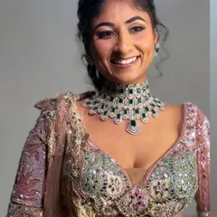 The final look. Her smile shows how happy and confident she feels, and that's always my goal. The diamond and emerald jewelry perfectly complements the colors in her outfit.