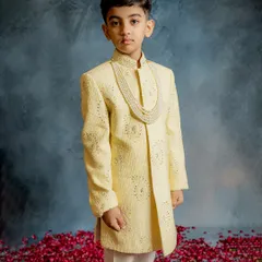 Elegance and poise captured in our pale yellow sherwani. This outfit features subtle all-over embroidery and is paired with a traditional pearl mala, making it a sophisticated choice for any formal occasion.