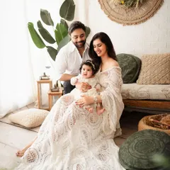 The perfect family portrait in a relaxed, earthy setting. This family of three looks so happy and comfortable on the boho-style sofa, creating a warm and authentic memory.
