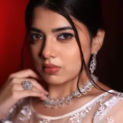 A striking close-up of a Christian bridal look. The focus is on the defined, winged eyeliner and soft nude lip, creating a modern yet timeless appeal.