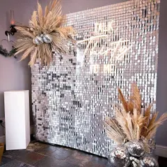 "Talk Thirty To Me." A silver sequin wall is the perfect backdrop for a milestone birthday. The pampas grass and disco balls add a touch of boho glam.
