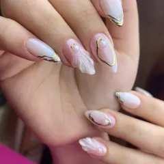 The perfect blend of modern and romantic for a bride. This design combines sheer nude extensions with delicate gold accents, pearls, and a beautifully sculpted 3D fabric-like effect on the accent nail.