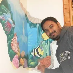 Here I am with a 3D-effect underwater mural that looks like the wall is broken away to reveal a coral reef. This technique is a great way to add depth and a surprising element to a room, making the art feel interactive and alive.