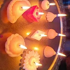 A beautiful arrangement of floating candles made with my various mithai-themed molds, including Gujiya, Modak, and Ladoo shapes. These are perfect for creating a festive ambiance in a traditional urli.
