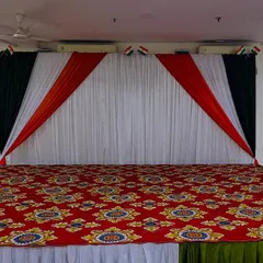 A clean view of the Independence Day stage with its patterned red carpet and simple, patriotic backdrop.