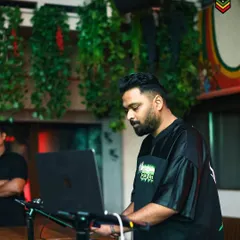 Focused on the laptop and decks during a set at Raasta. This is where I cook up the vibe for the night, blending tracks seamlessly.