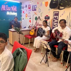 A snapshot of our classroom during a group guitar lesson. With instruments on the walls and students focused on their music sheets, our academy provides an inspiring atmosphere for learning.