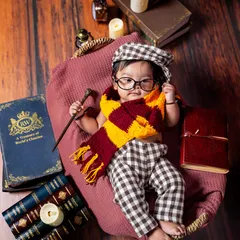For the little wizard in your life. This Harry Potter themed infant shoot comes complete with a magic wand, a Gryffindor scarf, and vintage books to create a truly magical scene.