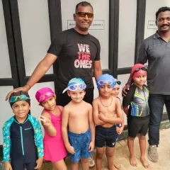 Here with my co-coach and our group of young swimmers. We believe in building a strong foundation from the start. These kids are the future of the sport, and it is our job to guide them.