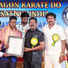 Here I am at an event for the White Dragon Karate Do organization, presenting an award to a fellow master. It is an honor to be part of a community that recognizes and respects each other's achievements.