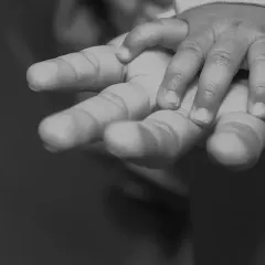 A tiny hand holding on, a simple yet powerful symbol of trust and connection. I believe these small, black and white detail shots often tell the biggest stories about family bonds.