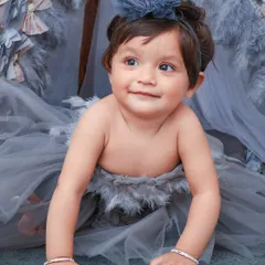 A unique and whimsical portrait with a feather-adorned teepee and a beautiful grey tulle outfit. I love creating one-of-a-kind artistic setups.