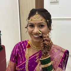 The delicate details make all the difference in a traditional Maharashtrian bridal look. Here, I'm adjusting the classic Maharashtrian nath, ensuring it sits perfectly. Her makeup is kept soft and radiant to complement the rich purple saree and gold jewelry.