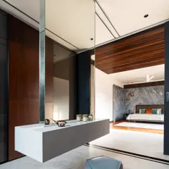 A suspended vanity with a wrap-around mirror creates an ethereal dressing area in the Timber Edge project. This floating element blurs boundaries and enhances the sense of space.