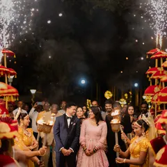 I believe every couple deserves a spectacular entrance. Here, we created a magical pathway with traditional umbrellas, torch-bearing dancers, and cold pyro sparklers to welcome the couple into their reception, making for an unforgettable moment.