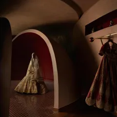 In designing for a fashion brand, the space must become an extension of the couture. Here, a bridal lehenga is presented within a sculpted, womb-like alcove, transforming the act of viewing into a private ritual. The architecture itself becomes a garment, draping the brand's story around the client.