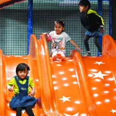 Students having a fantastic time on the slide during their school outing. It's a great way to combine physical activity with fun.