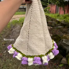 Unfurling the crochet blanket to show its generous size. The main body is stitched with soft, natural-colored cotton, perfect for a baby's sensitive skin.